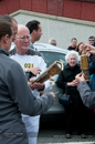 The Olympic flame is transferred to the first Shetland torch, carried by John Nicolson