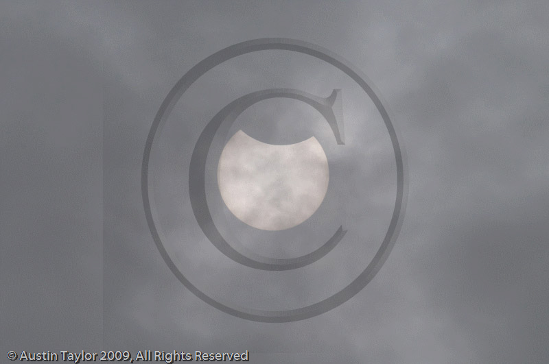 Partial phase of the Solar Eclipse at Shanghai Sculpture Park before the sun was hidden by thick cloud, rain and a thunderstorm that obscured the eclipse
