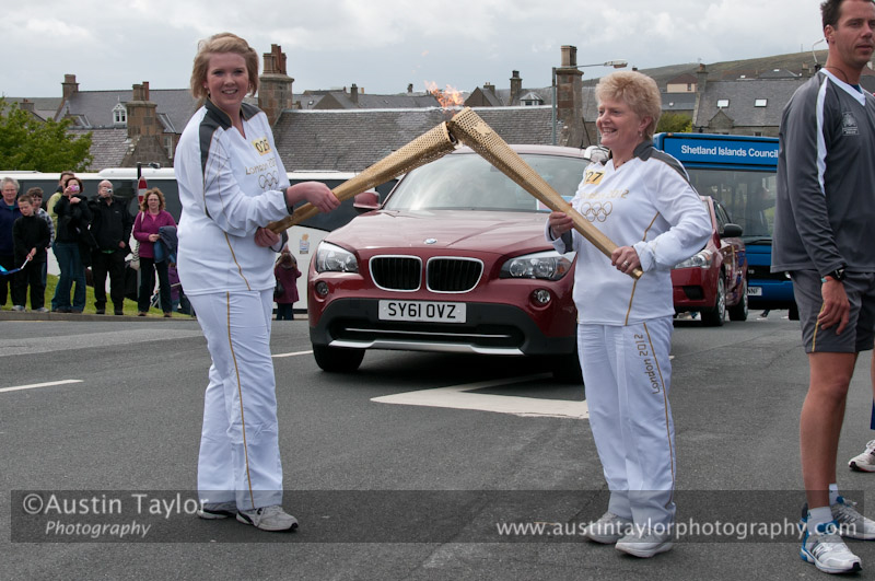 Emily Shaw passes the flame to Belle Spence