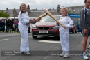 Emily Shaw passes the flame to Belle Spence