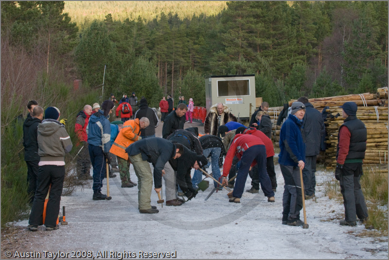 Mushers clearing ice off the track at the 25th Anniversary Siberian Husky Club of Great Britain Aviemore Sled Dog Rally 2008, Rothiemurchus Forest, Aviemore, Highland