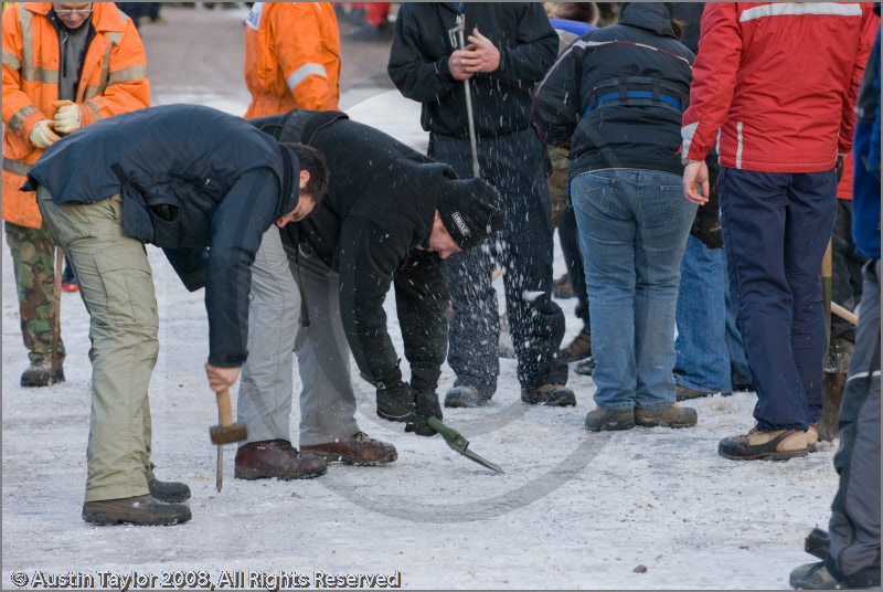 Mushers clearing ice off the track at the 25th Anniversary Siberian Husky Club of Great Britain Aviemore Sled Dog Rally 2008, Rothiemurchus Forest, Aviemore, Highland