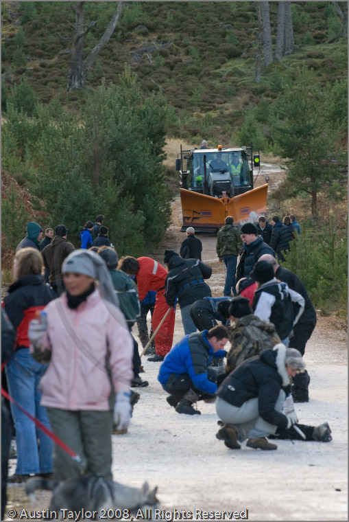Mushers clearing ice off the track at the 25th Anniversary Siberian Husky Club of Great Britain Aviemore Sled Dog Rally 2008, Rothiemurchus Forest, Aviemore, Highland