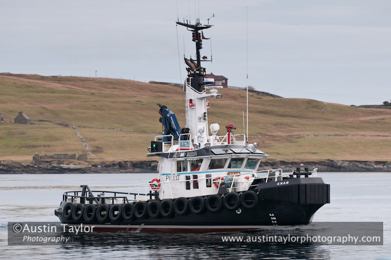 Up Helly-Aa 2011: morning procession - waiting for the arrival of the Jarl Squad at Alexandra Wharf - pilot boat Knab takes a look at the galley