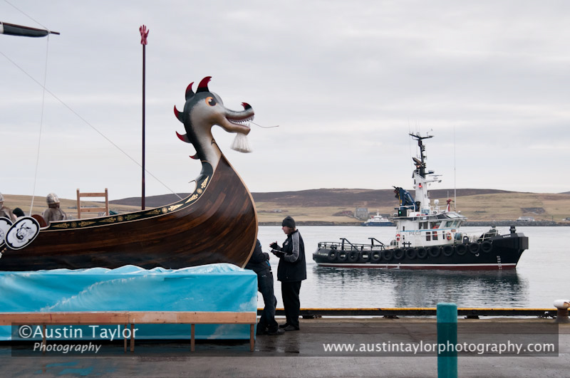 Up Helly-Aa 2011: morning procession - waiting for the arrival of the Jarl Squad at Alexandra Wharf - pilot boat Knab takes a look at the galley