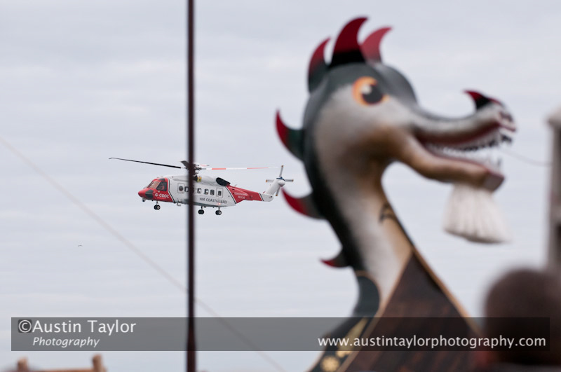 Up Helly-Aa 2011: morning procession - the Coastguard helicopter surveys the galley Jägare at Alexandra Wharf