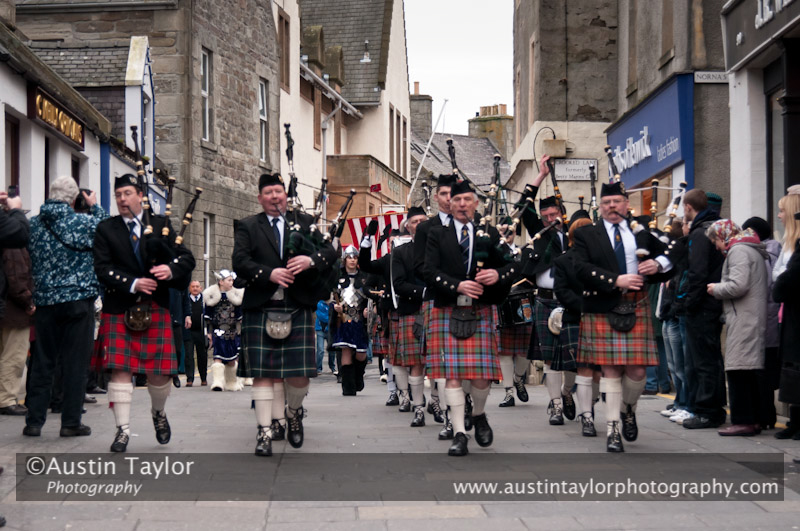 Up Helly-Aa 2011: morning procession - Lerwick Royal British Legion Pipe Band lead the Junior Jarl Squad through Commercial Street