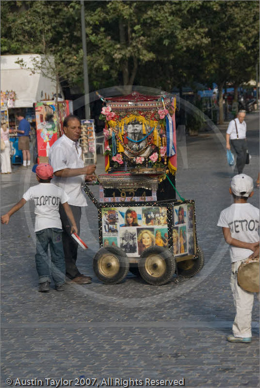 Man and boy collecting with street organ Athens, Greece 21 September 2007
